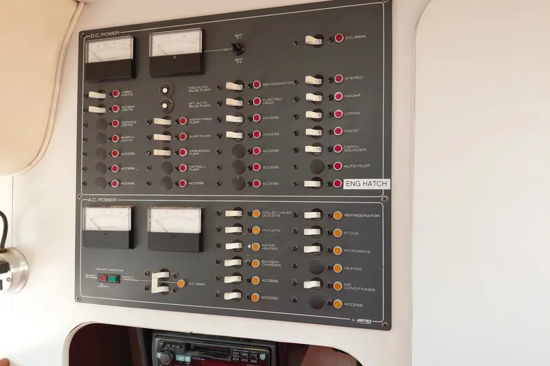 Slide: The Image of Control panel of a 1991 Tiara Yachts 3100 Open, featuring various switches and gauges. - 25