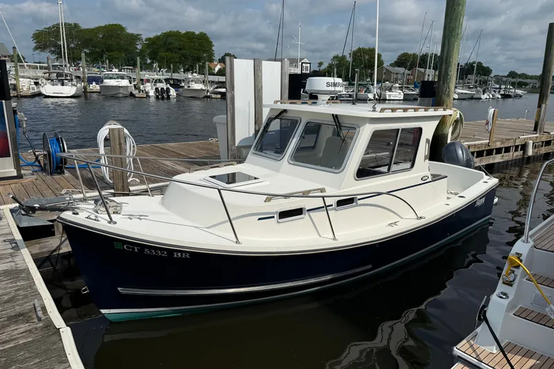 The Image of 2020 Eastern 248 Islander boat docked at marina with other vessels in background. - 0
