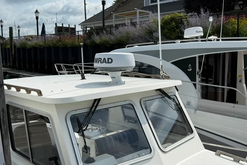 Slide: The Image of 2020 Eastern 248 Islander boat docked, featuring radar equipment and sleek design. - 2