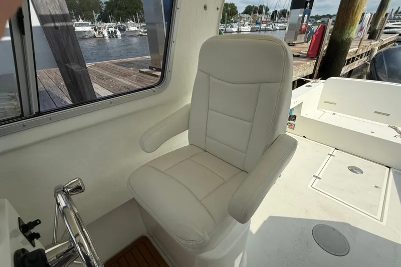 Slide: The Image of Captain's chair on 2020 Eastern 248 Islander boat, docked at marina. - 4