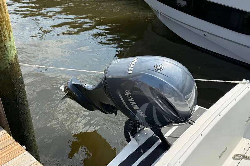 Slide: The Image of Yamaha outboard motor on 2020 Eastern 248 Islander boat docked by water. - 8