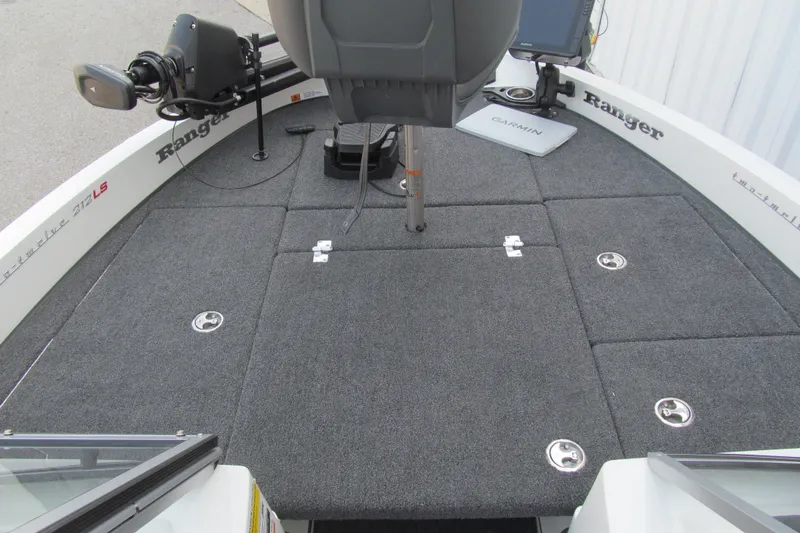 Slide: The Image of 2024 Ranger 212LS boat deck with carpeted surface and fishing equipment. - 8