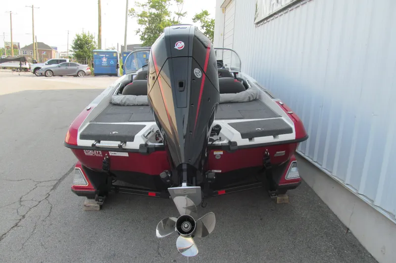 Slide: The Image of 2024 Ranger 212LS boat with powerful outboard motor, parked outdoors. - 4