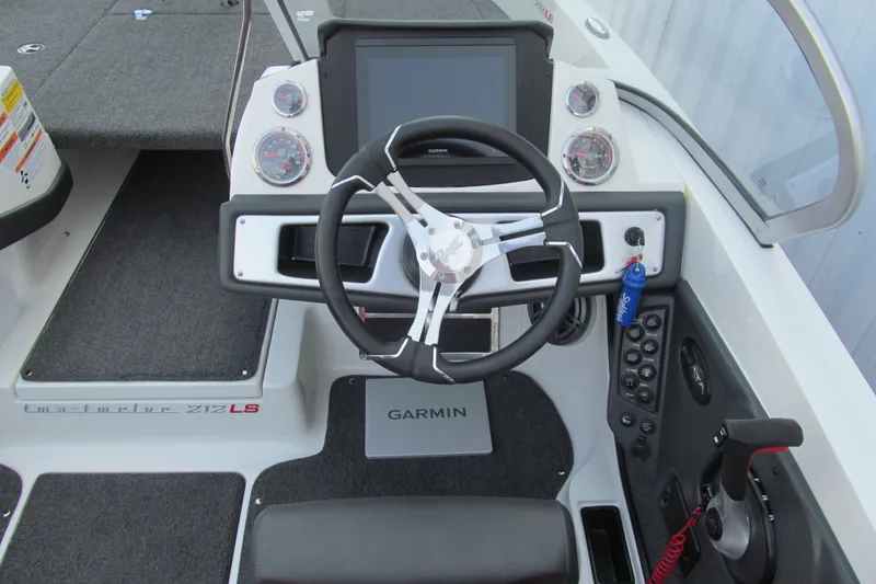 Slide: The Image of 2024 Ranger 212LS boat dashboard with steering wheel and Garmin display. - 6