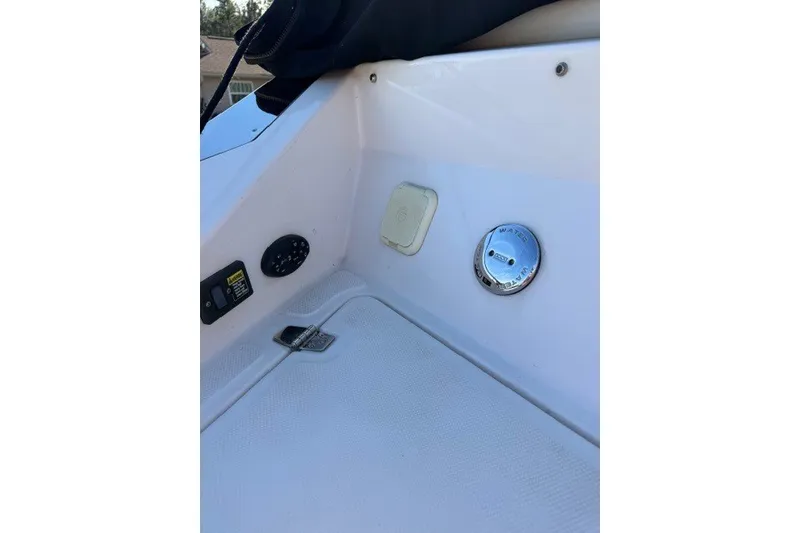Slide: The Image of 2005 Regal 2200 Bowrider interior detail with control panel and water access. - 12