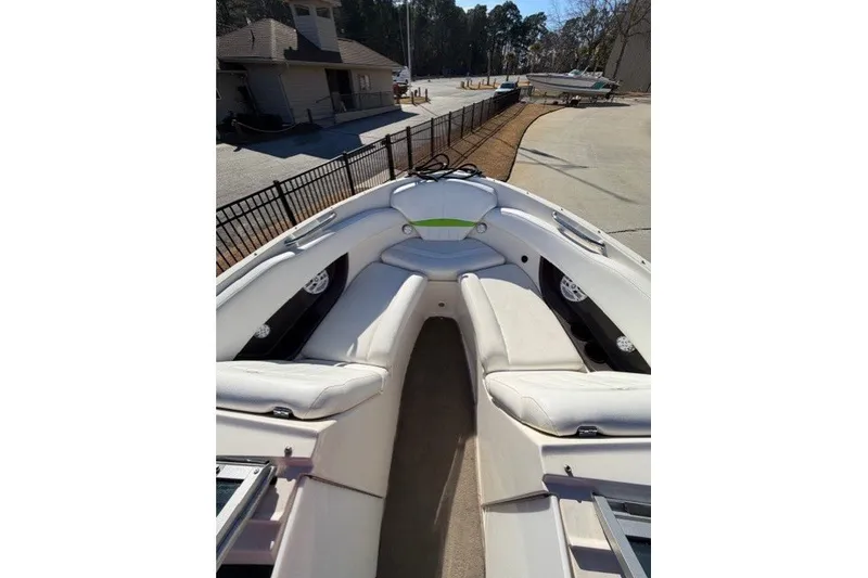 Slide: The Image of 2005 Regal 2200 Bowrider boat interior with white seating and open bow design. - 9
