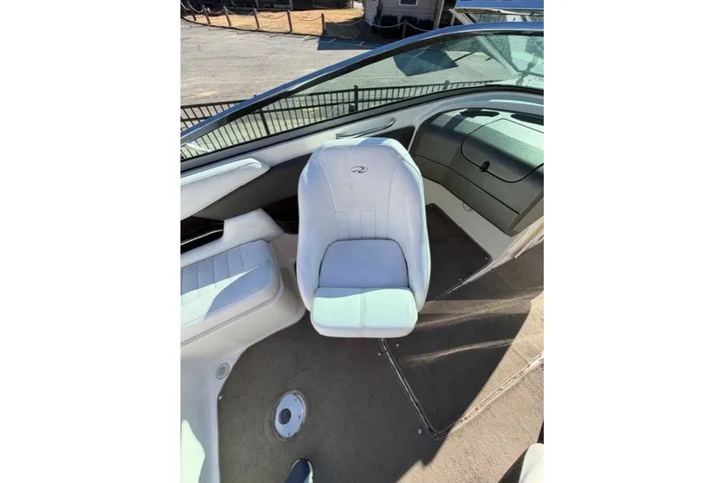 Slide: The Image of 2005 Regal 2200 Bowrider interior with white seating and dashboard view. - 7