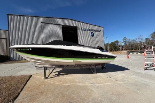 Slide: The Image of 2005 Regal 2200 Bowrider boat at Lighthouse Marina, displayed outdoors on a sunny day. - 15
