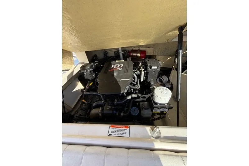 Slide: The Image of Engine compartment of a 2005 Regal 2200 Bowrider boat, showcasing the 5.0 MPI engine. - 10