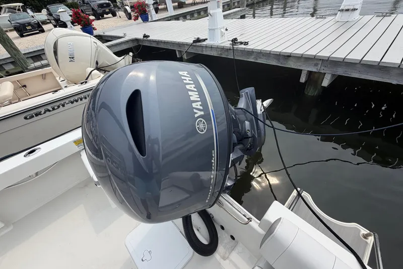 Slide: The Image of 2024 Parker 1801 Center Console with Yamaha outboard motor docked near Grady-White boat. - 24