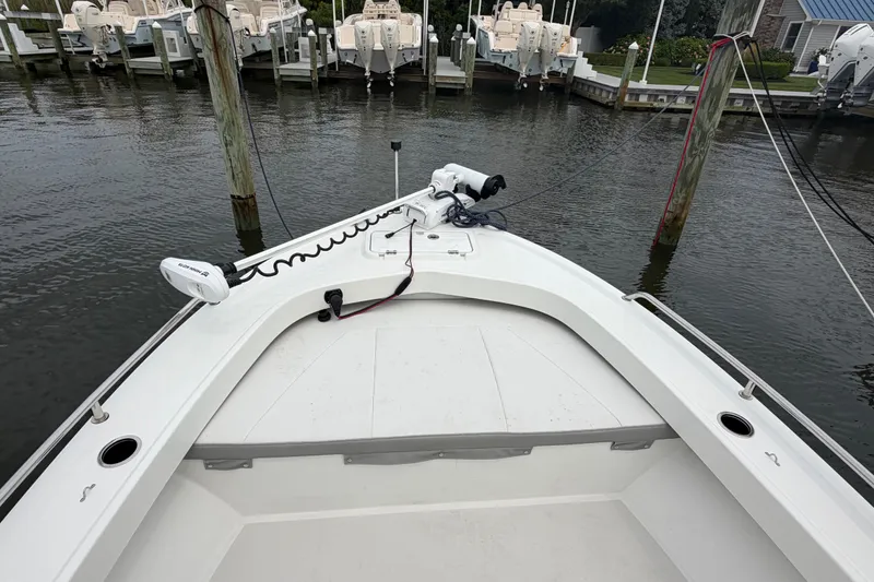 Slide: The Image of 2024 Parker 1801 Center Console boat docked at marina, featuring spacious bow area. - 5