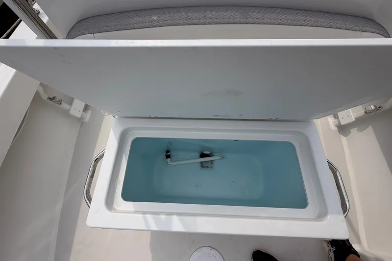 Slide: The Image of 2024 Parker 1801 Center Console boat storage compartment with open lid. - 10