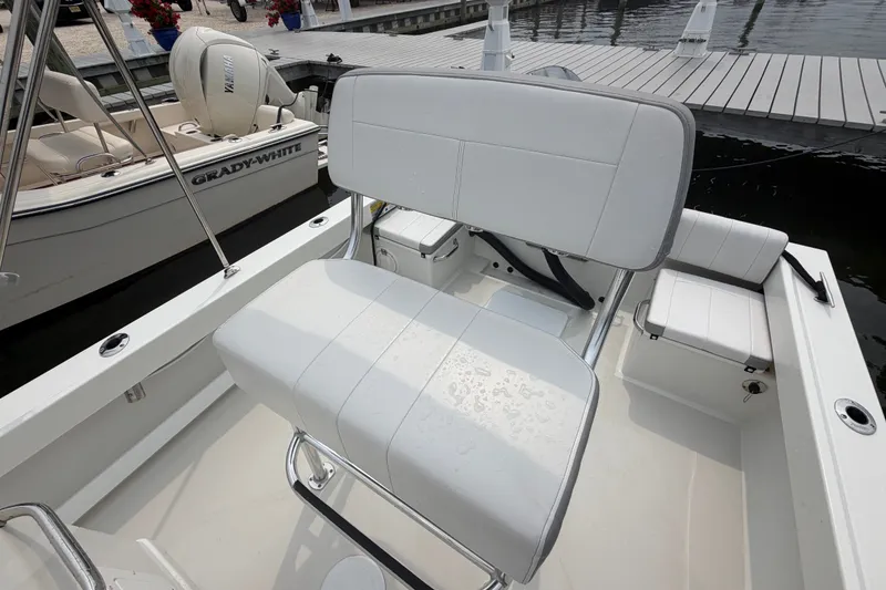 Slide: The Image of 2024 Parker 1801 Center Console boat interior with white seating and dockside view. - 20