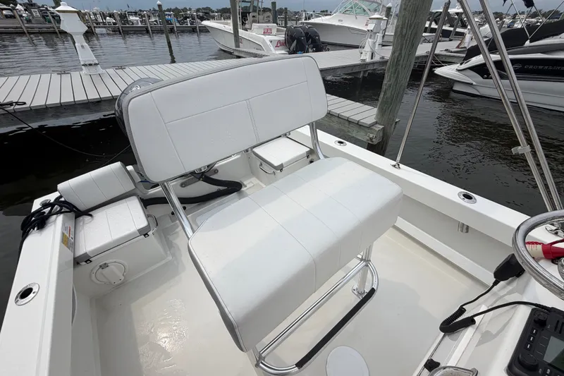 Slide: The Image of 2024 Parker 1801 Center Console boat interior with white seating at marina. - 19