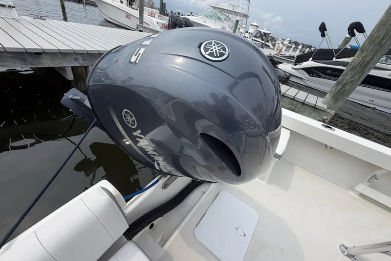 Slide: The Image of 2024 Parker 1801 Center Console boat with Yamaha outboard motor docked at marina. - 23