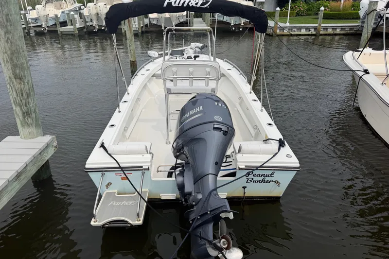 Slide: The Image of 2024 Parker 1801 Center Console boat docked with Yamaha outboard motor. - 27