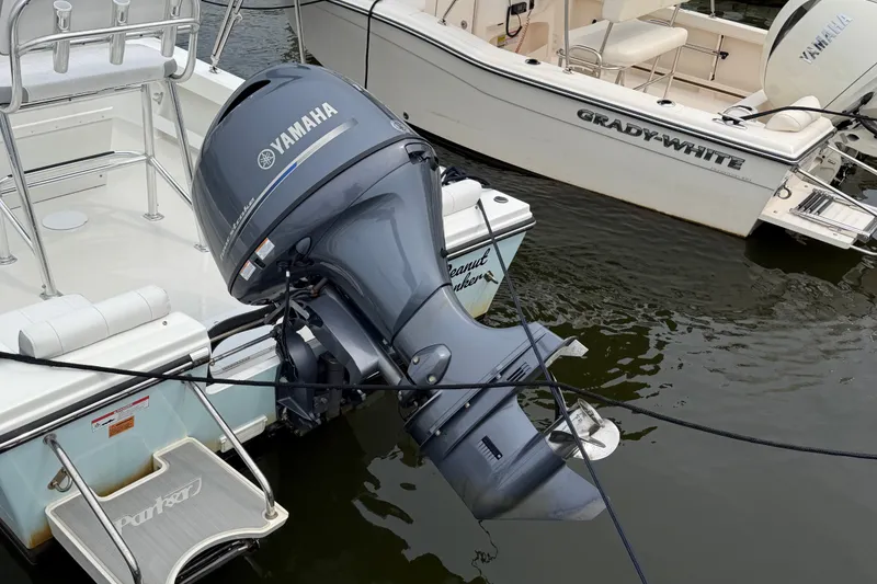 Slide: The Image of 2024 Parker 1801 Center Console boat with Yamaha outboard motor docked beside Grady-White. - 26