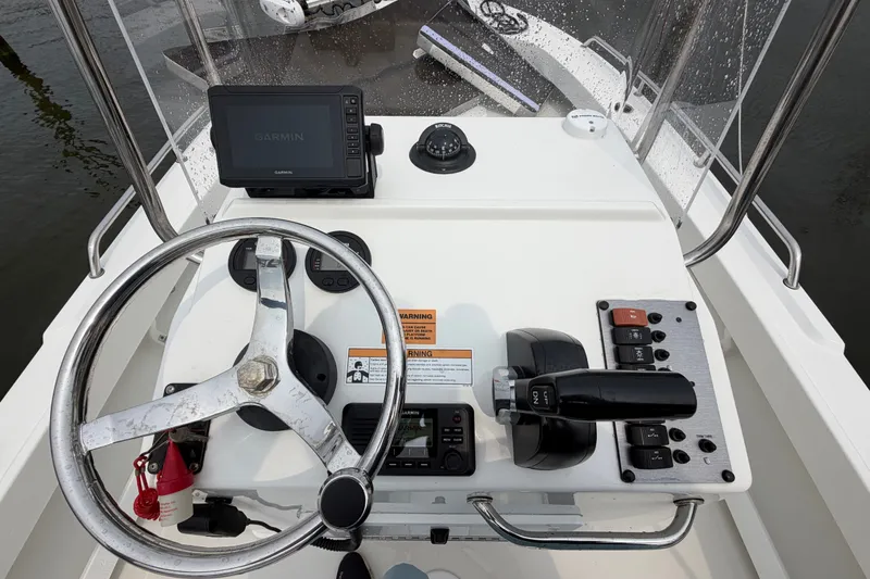 Slide: The Image of 2024 Parker 1801 Center Console boat dashboard with steering wheel and Garmin navigation system. - 13