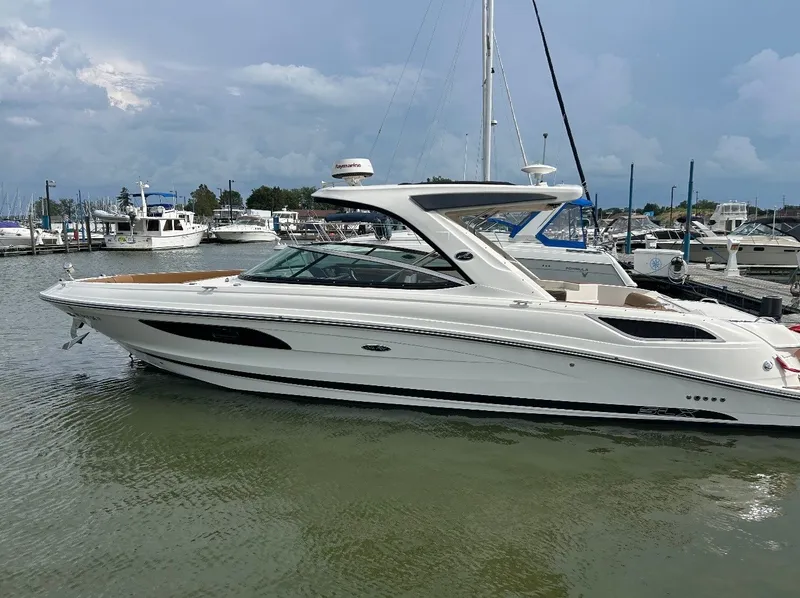 Slide: The Image of A white 2015 Sea Ray SLX 350 boat is docked in a marina. - 3