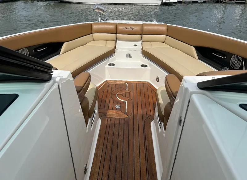 Slide: The Image of The image shows the cockpit of a 2015 Sea Ray SLX 350 with elegant seating and wood flooring. - 8