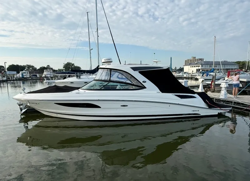 The Image of A 2015 Sea Ray SLX 350 is docked in the water. It features a sleek, modern design. - 0