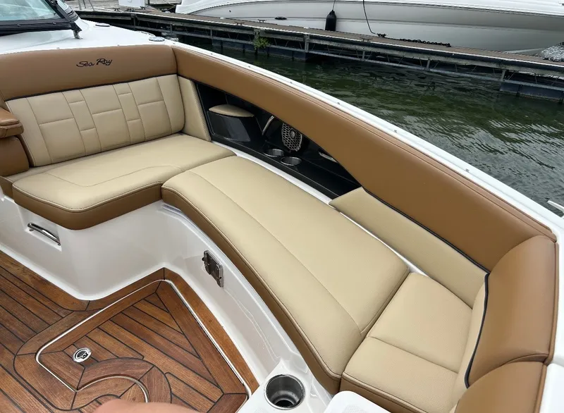 Slide: The Image of The 2015 Sea Ray SLX 350 features a luxurious seating area with cream cushions and wood flooring. - 6