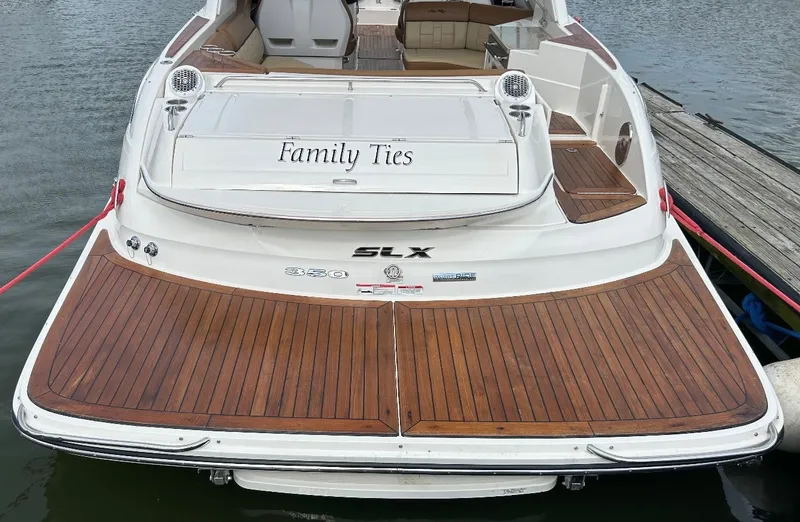 Slide: The Image of The image shows the stern of a 2015 Sea Ray SLX 350 boat with a wooden deck. - 4