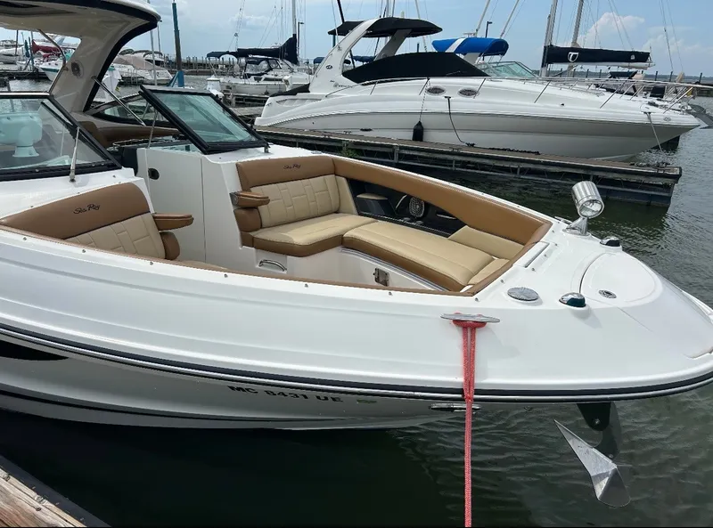 Slide: The Image of A 2015 Sea Ray SLX 350 docked. It features a white exterior and comfortable seating. - 5