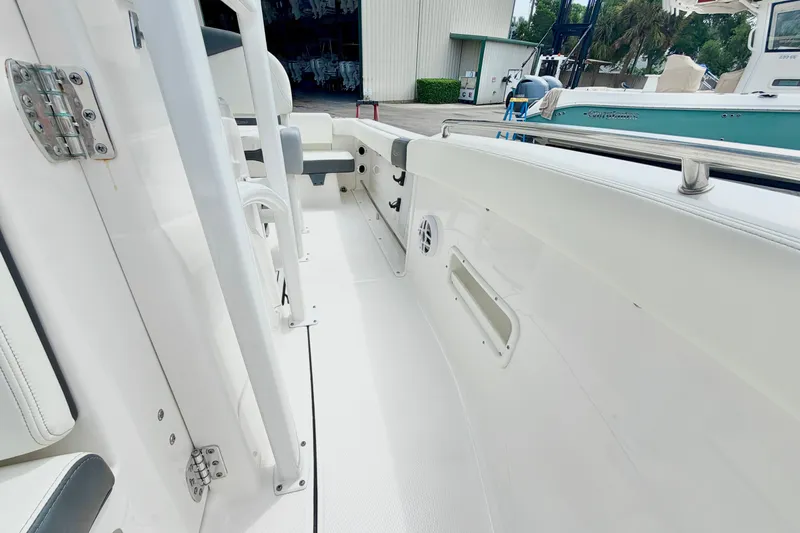 Slide: The Image of 2024 Robalo R222 Center Console boat interior with white seating and stainless steel railing. - 20