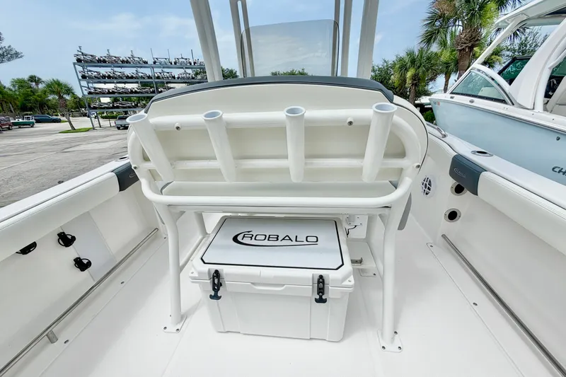 Slide: The Image of 2024 Robalo R222 Center Console boat interior with rod holders and storage compartment. - 10