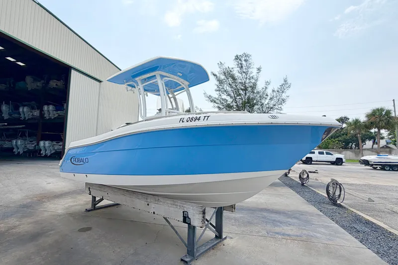Slide: The Image of 2024 Robalo R222 Center Console boat in blue, displayed outdoors on a stand. - 6