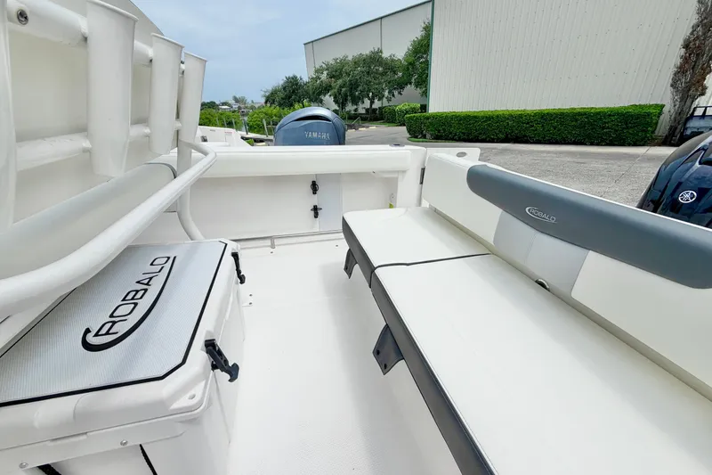 Slide: The Image of 2024 Robalo R222 Center Console boat interior with seating and storage, featuring Yamaha engine. - 11