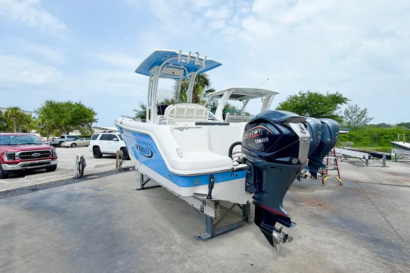 Slide: The Image of 2024 Robalo R222 Center Console boat with Yamaha engines on display outdoors. - 3