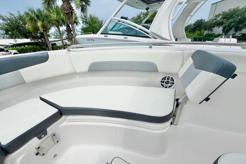 Slide: The Image of 2024 Robalo R222 Center Console boat interior with cushioned seating and speaker. - 28