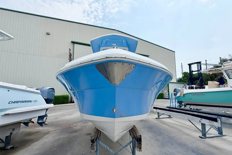 Slide: The Image of 2024 Robalo R222 Center Console boat in blue, displayed outdoors on a trailer. - 7