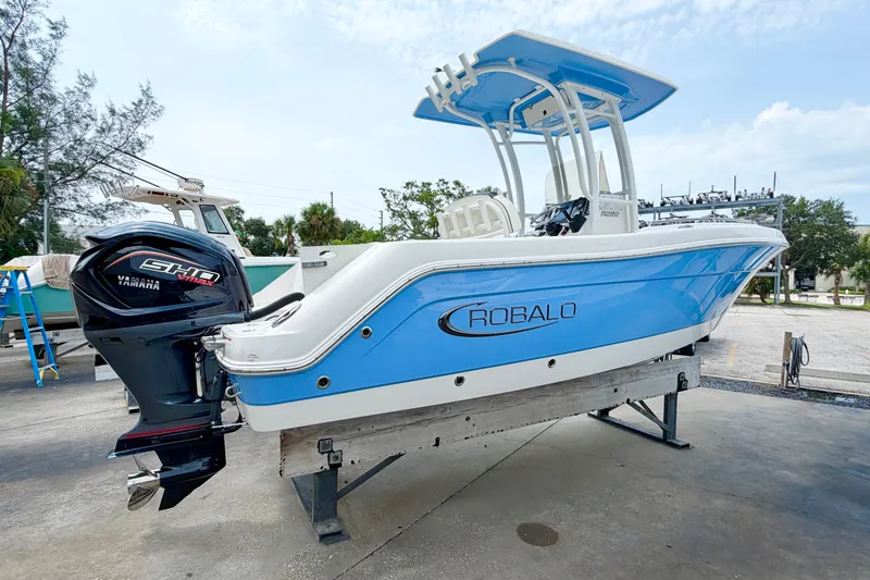 Slide: The Image of 2024 Robalo R222 Center Console boat with Yamaha engine, displayed outdoors. - 5