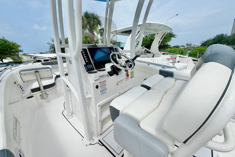 Slide: The Image of 2024 Robalo R222 Center Console boat interior with steering wheel and seating. - 16