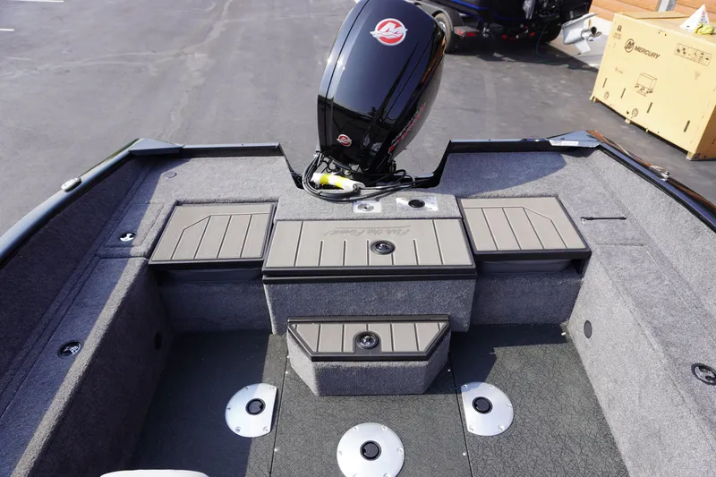 Slide: The Image of 2027 Tracker Pro Guide V-175 Combo boat interior with motor, storage compartments, and seating. - 8