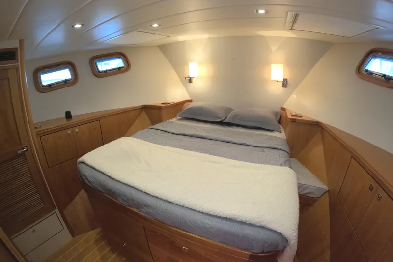 Slide: The Image of Luxurious cabin interior of 2021 Kadey-Krogen 50 Open yacht with cozy bed and wooden accents. - 30