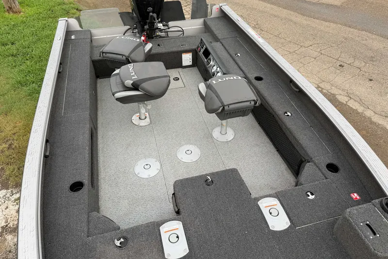 Slide: The Image of 2025 Lund 1875 Pro Guide boat interior with seating and storage compartments. - 6