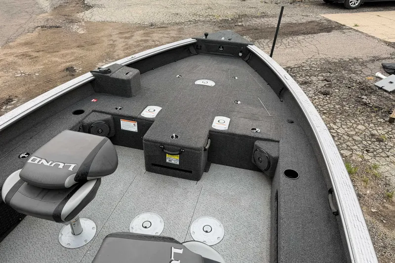 Slide: The Image of 2025 Lund 1875 Pro Guide boat interior with seating and storage compartments. - 9
