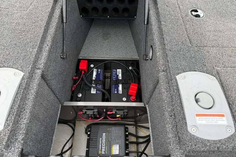 Slide: The Image of 2025 Lund 1875 Pro Guide boat battery compartment with precision charger and wiring. - 10