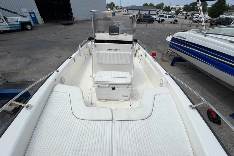 Slide: The Image of Boston Whaler 22 Dauntless 2000 boat interior with seating and console, docked at marina. - 14