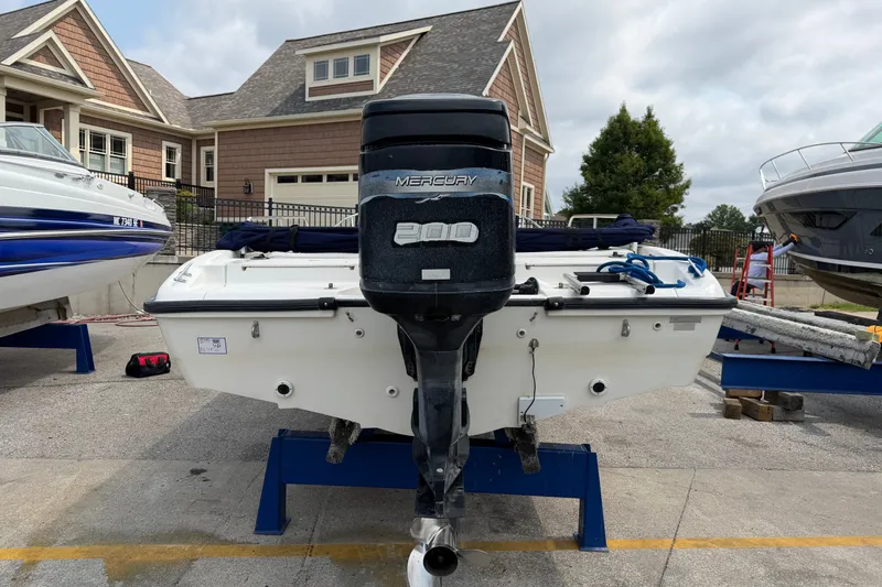 Slide: The Image of Boston Whaler 22 Dauntless 2000 with Mercury 200 engine, docked near residential area. - 21