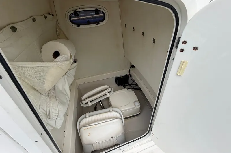 Slide: The Image of Interior cabin of a 2000 Boston Whaler 22 Dauntless boat with seating and storage. - 16