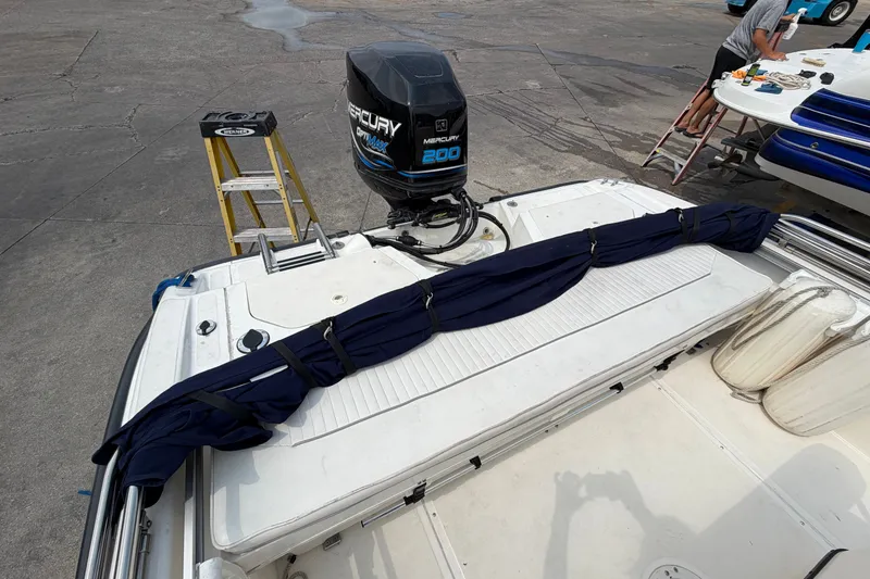 Slide: The Image of Boston Whaler 22 Dauntless 2000 with Mercury 200 engine, docked and undergoing maintenance. - 5
