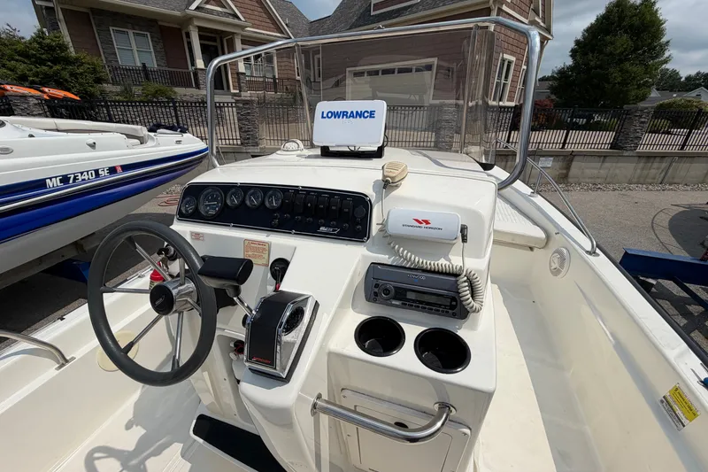 Slide: The Image of Boston Whaler 22 Dauntless 2000 boat console with steering wheel and navigation equipment. - 9
