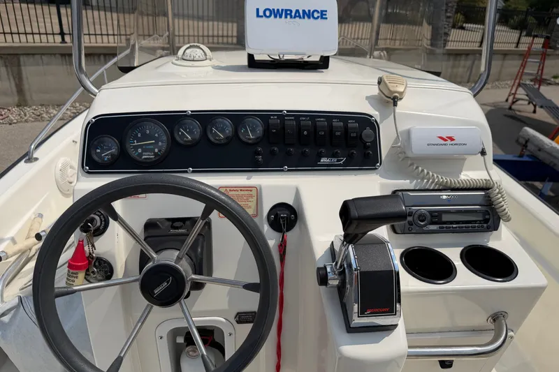 Slide: The Image of Control panel of a 2000 Boston Whaler 22 Dauntless boat with steering wheel and navigation equipment. - 10