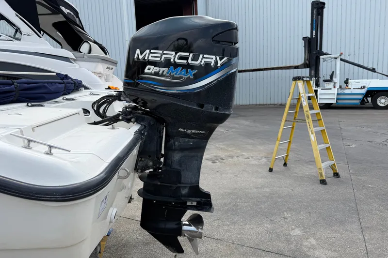 Slide: The Image of Boston Whaler 22 Dauntless 2000 with Mercury OptiMax outboard motor in a marina setting. - 20