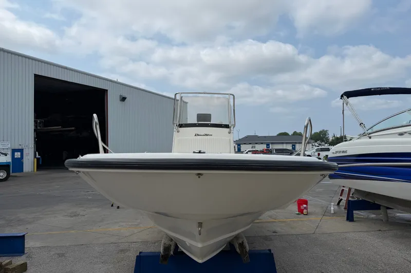Slide: The Image of Boston Whaler 22 Dauntless boat, 2000 model, docked near a storage facility. - 18